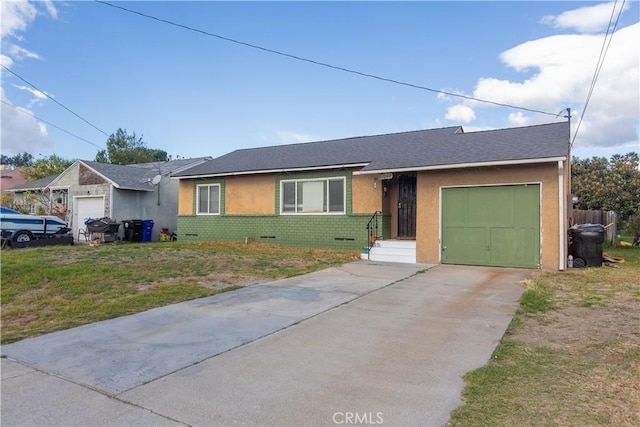 single story home featuring a front lawn and a garage