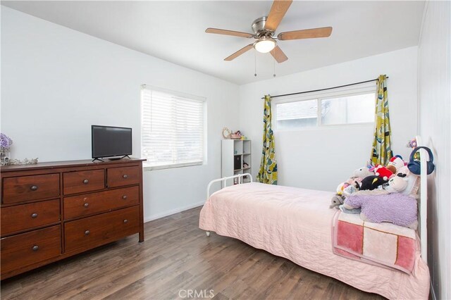 bedroom with ceiling fan and dark wood-type flooring