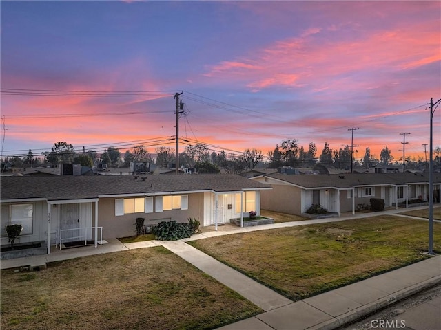 single story home featuring a yard