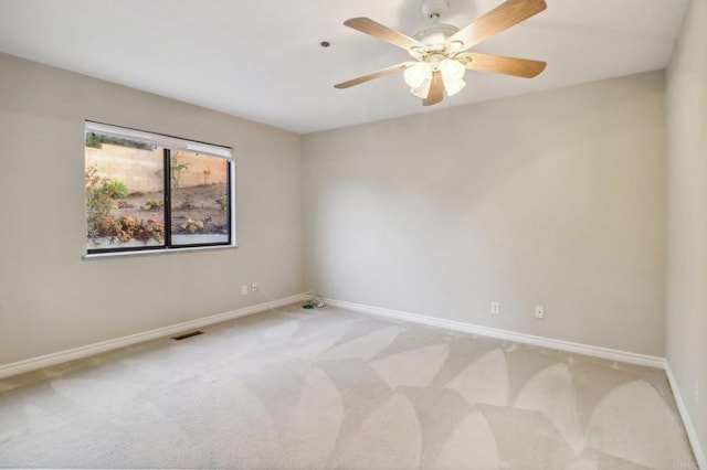 unfurnished room with ceiling fan and light colored carpet