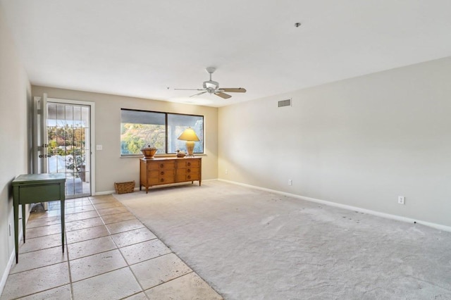 unfurnished room with light colored carpet and ceiling fan