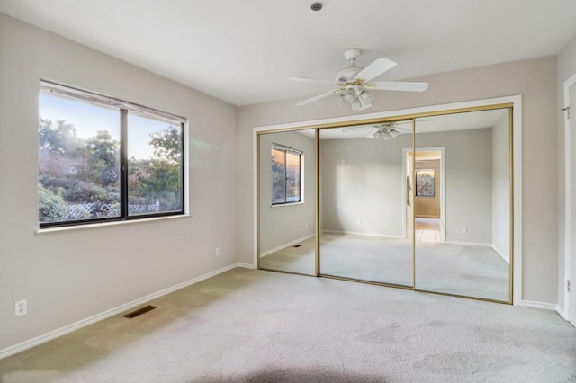 unfurnished bedroom with a closet, ceiling fan, and carpet flooring