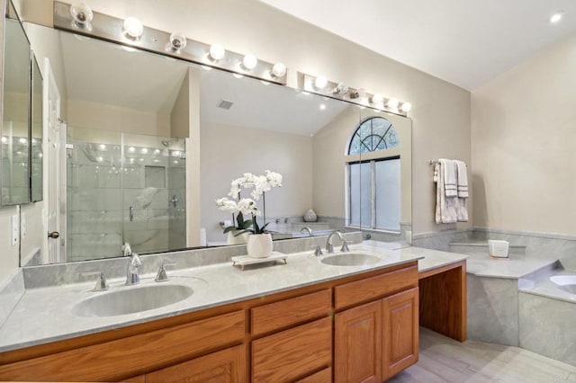 bathroom featuring lofted ceiling, separate shower and tub, and vanity