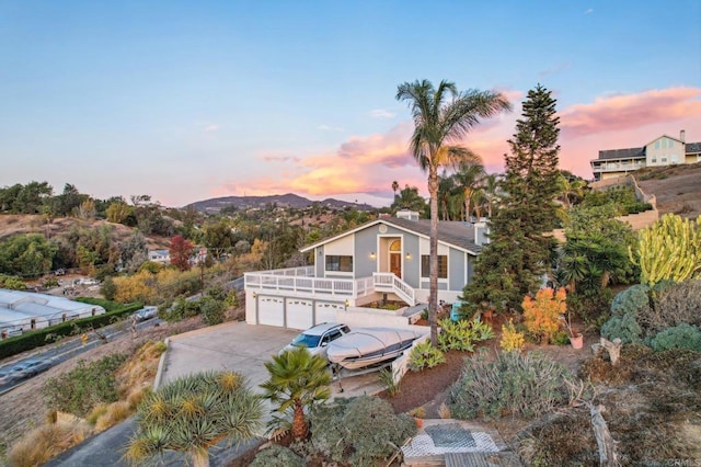 view of front of house with a garage and a mountain view