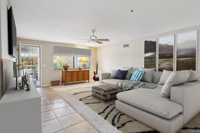 tiled living room with ceiling fan