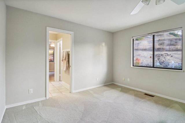 carpeted spare room with ceiling fan