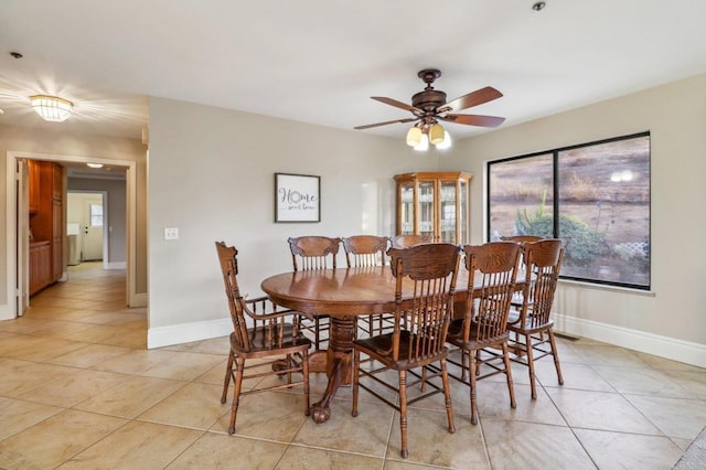 dining space featuring ceiling fan and light tile patterned flooring