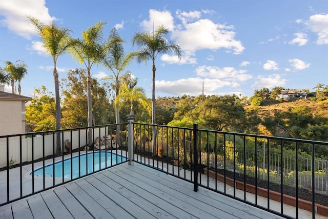 wooden deck featuring a fenced in pool