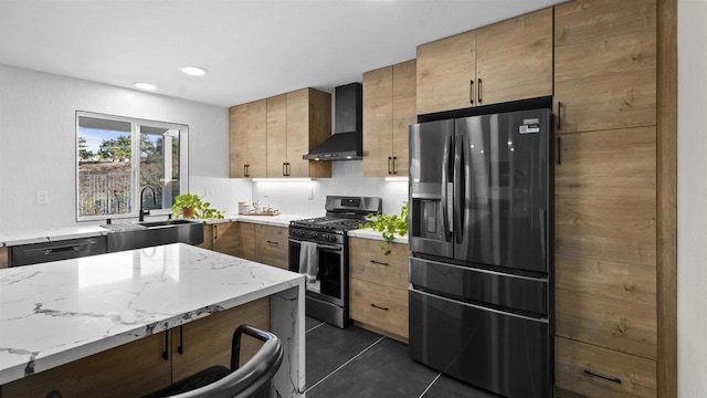 kitchen with light stone countertops, dark tile patterned floors, wall chimney range hood, stainless steel appliances, and sink