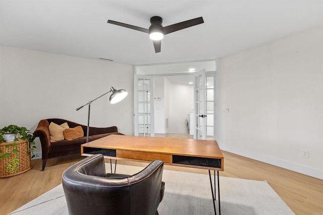 office featuring ceiling fan, hardwood / wood-style flooring, and french doors