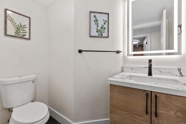 bathroom with toilet and vanity