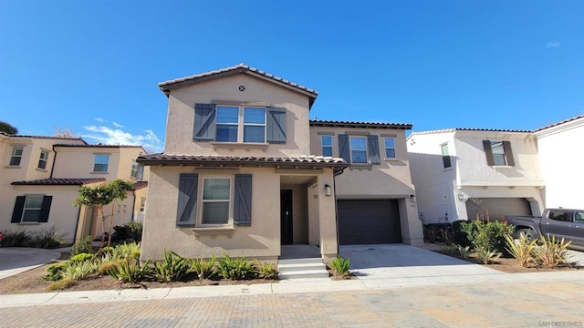 mediterranean / spanish home with a garage