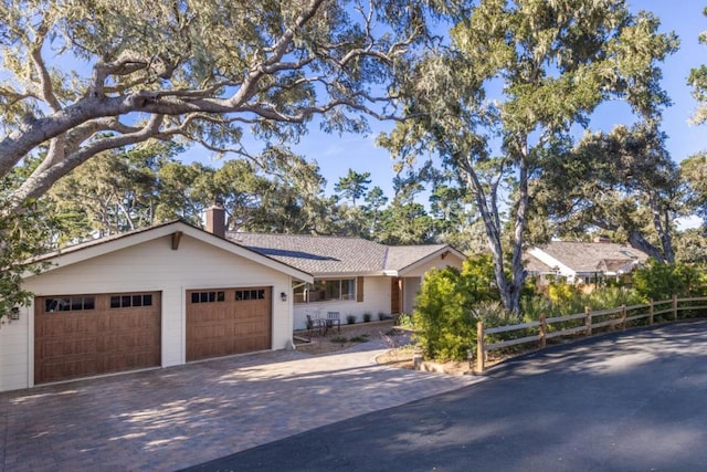 ranch-style home featuring a garage