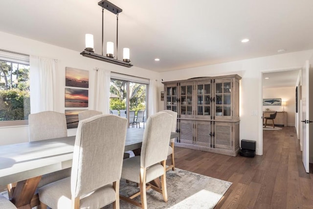 dining area featuring an inviting chandelier and dark hardwood / wood-style flooring