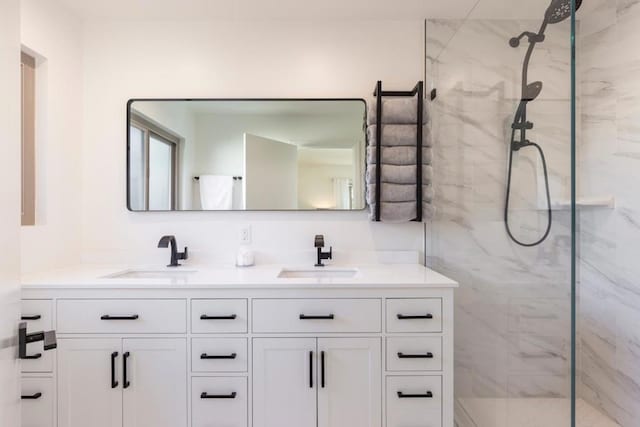 bathroom with vanity and a shower with door