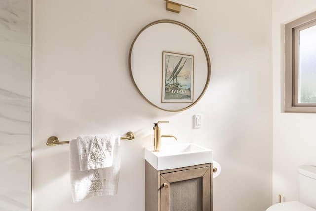 bathroom featuring vanity and toilet