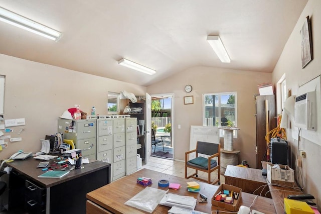 home office with lofted ceiling and light tile patterned floors