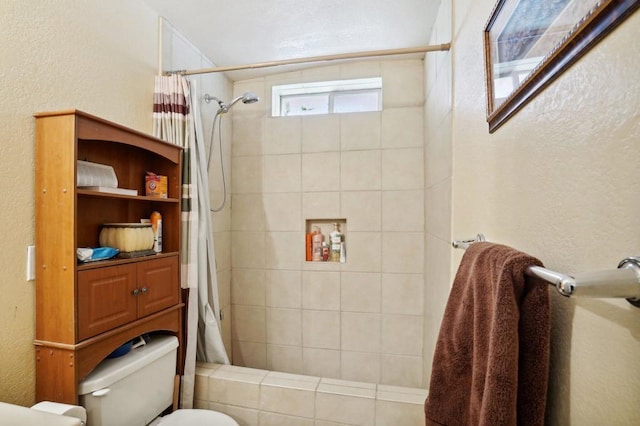 bathroom featuring toilet and a shower with curtain