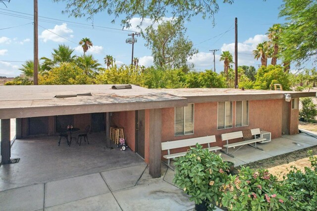 back of property with a patio