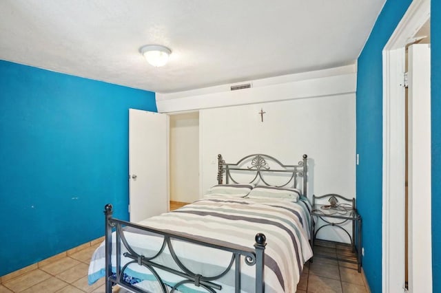 bedroom featuring light tile patterned flooring