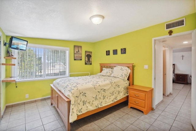 bedroom featuring light tile patterned floors