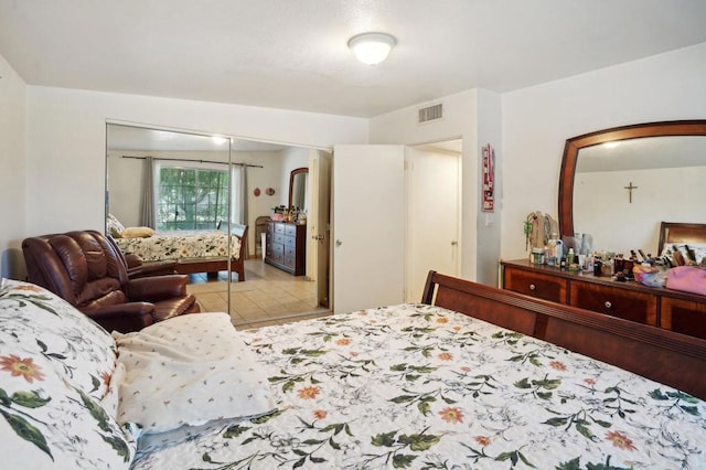 bedroom featuring light tile patterned floors and a closet