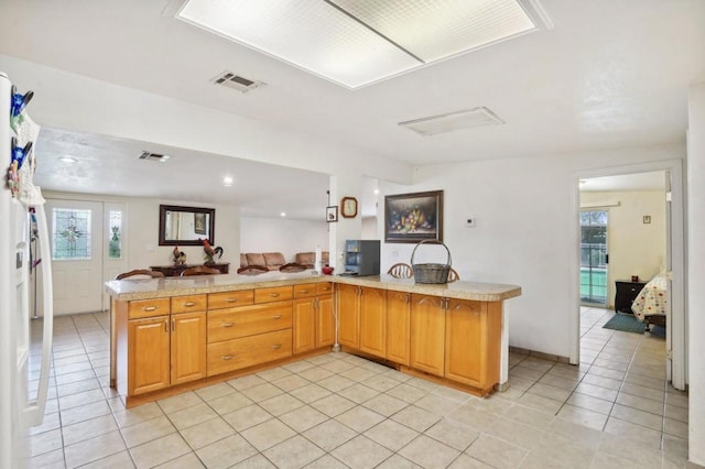 kitchen featuring light tile patterned flooring and kitchen peninsula