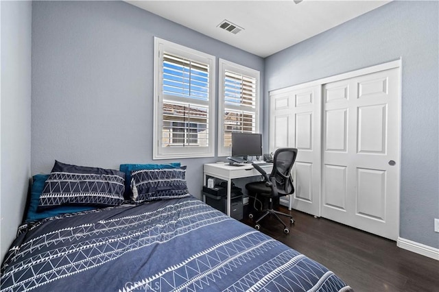 bedroom with a closet and dark hardwood / wood-style floors