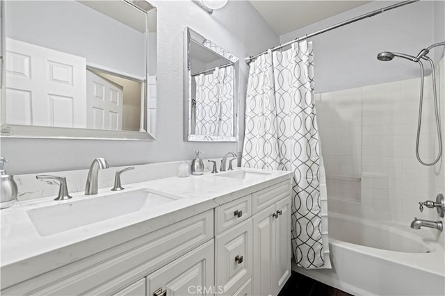 bathroom featuring shower / tub combo and vanity