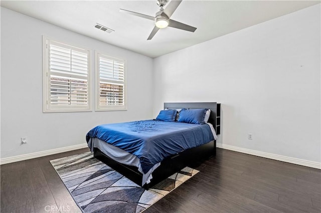 bedroom with ceiling fan and dark hardwood / wood-style flooring