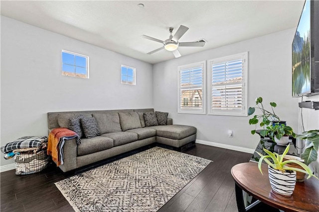 living room with ceiling fan and dark hardwood / wood-style floors