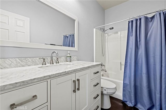 full bathroom featuring toilet, shower / bath combo, and vanity