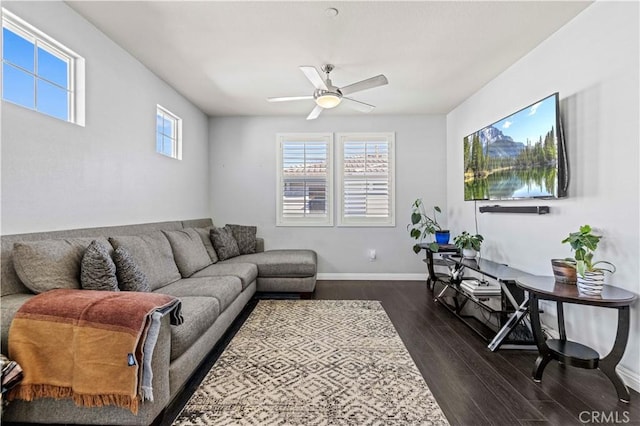 living room featuring ceiling fan and dark wood-type flooring