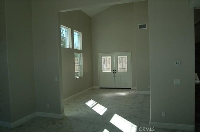 entrance foyer with a towering ceiling and french doors