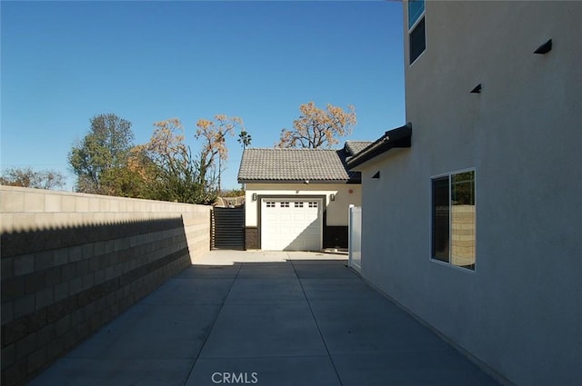 view of side of home featuring a garage