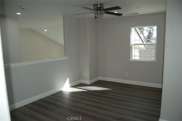 spare room featuring ceiling fan, dark hardwood / wood-style flooring, and lofted ceiling