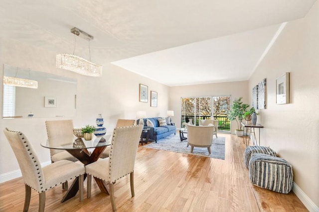 dining space featuring hardwood / wood-style floors and a notable chandelier