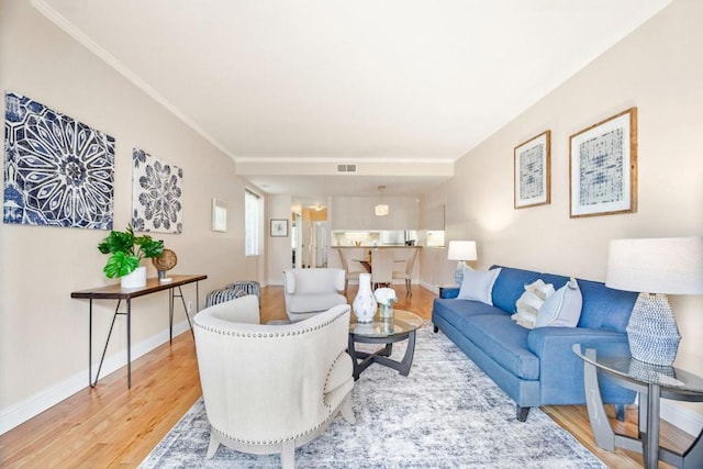 living room with crown molding and wood-type flooring