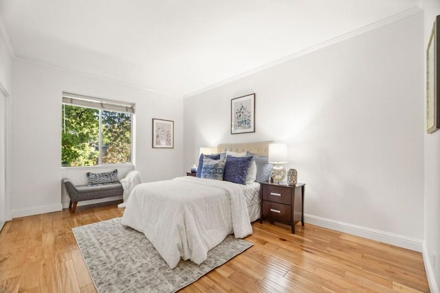 bedroom featuring ornamental molding and hardwood / wood-style floors