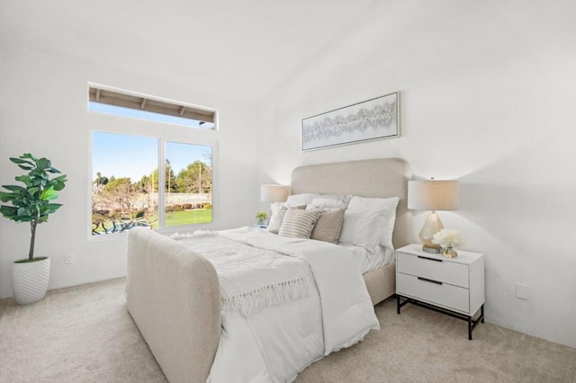 carpeted bedroom featuring lofted ceiling