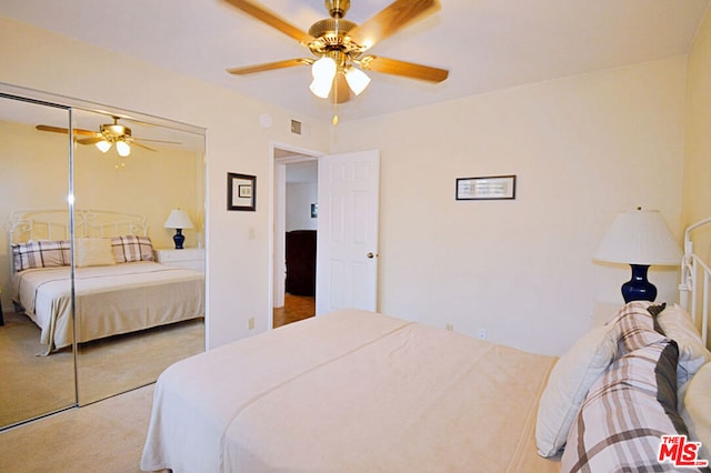 bedroom with ceiling fan, a closet, and carpet floors