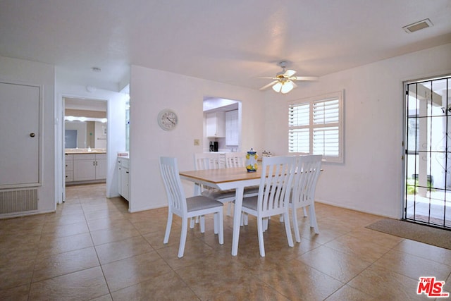 dining area with ceiling fan and light tile patterned flooring