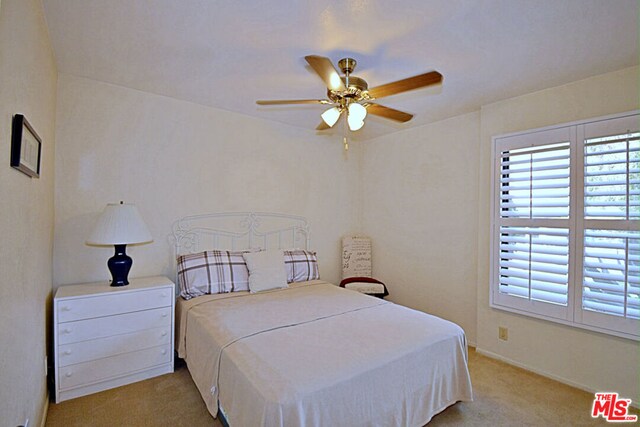 bedroom with ceiling fan and light carpet