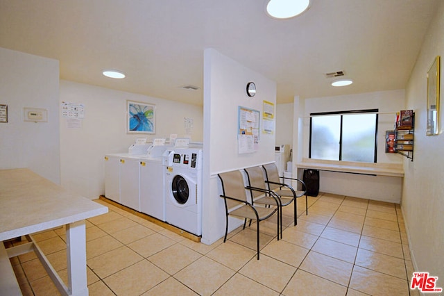 laundry area featuring light tile patterned floors and separate washer and dryer