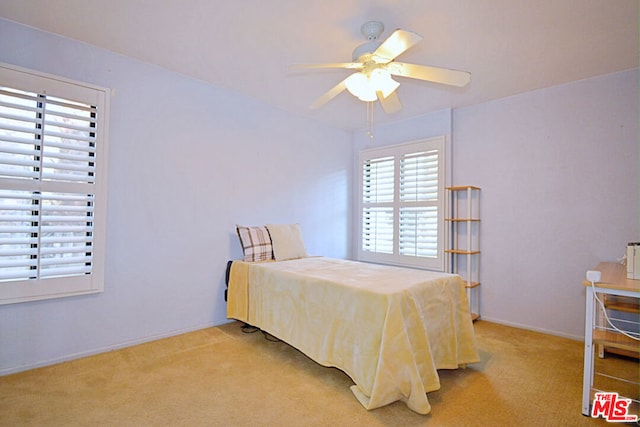 carpeted bedroom featuring ceiling fan