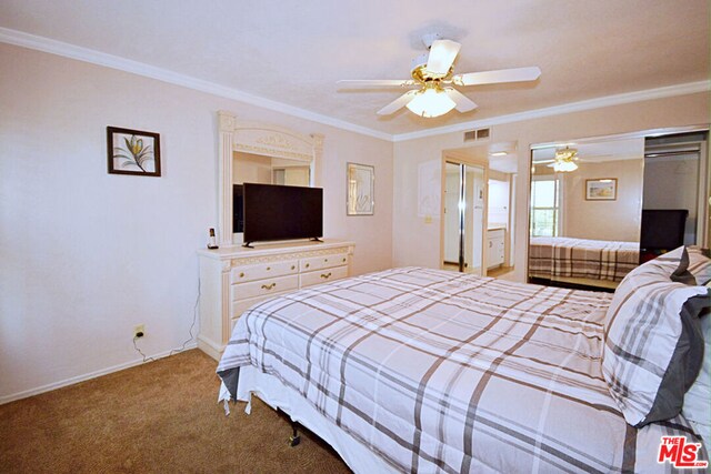 bedroom with ceiling fan, ornamental molding, and carpet flooring