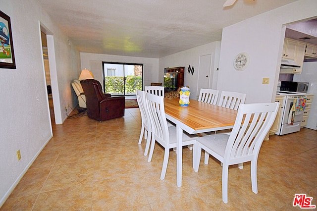 dining area with ceiling fan and light tile patterned flooring