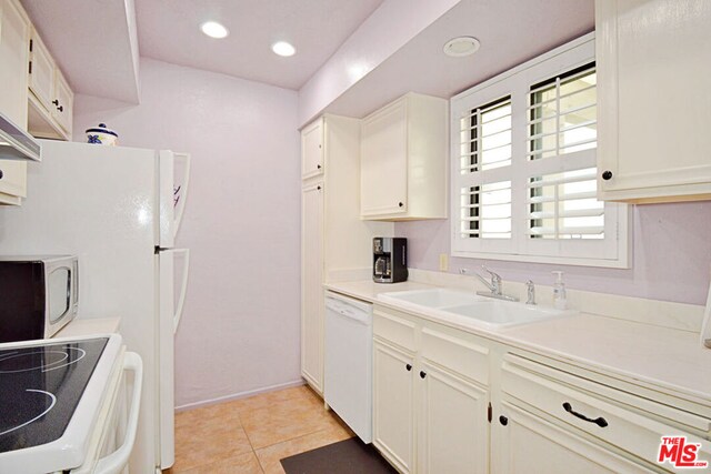 kitchen featuring light tile patterned floors, sink, and white appliances