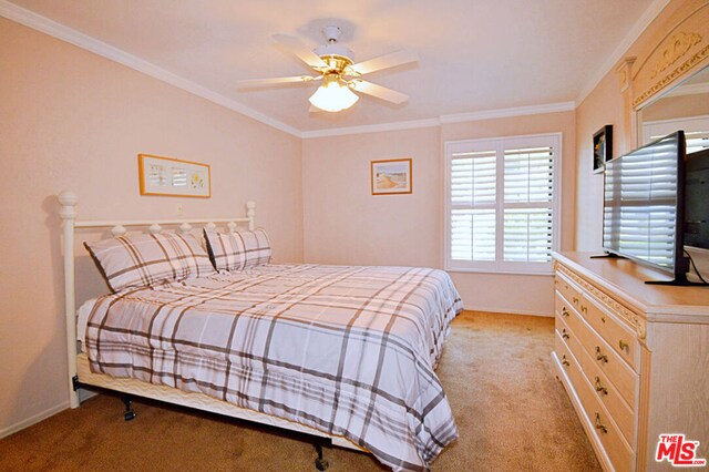 bedroom featuring ceiling fan, light colored carpet, and ornamental molding