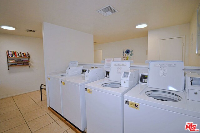 laundry room featuring light tile patterned floors and washing machine and clothes dryer